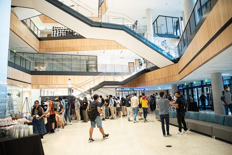 Students network at Rowling Hall on the University of Texas campus during the first Texas Sports Summit held in 2021.