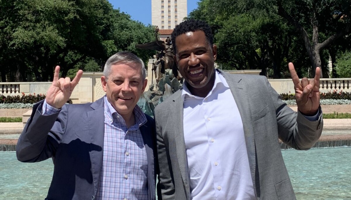 Mitch Bramlett, BBA ’92, MPA ’92, and Rod Adams, PwC’s advisory people & inclusion leader, show Longhorn pride during a campus visit last spring.