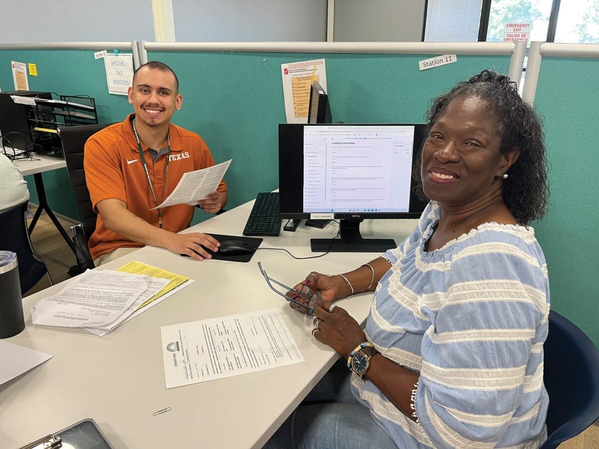 Teaguen Weise assists clients Mario Velazquez and Jessica Almaraz. Braulio Franyutti works with client Angela Washington.