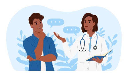 An African American female family doctor is talking to an elderly African American male patient.