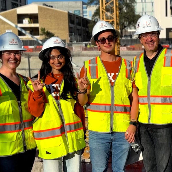 Members of McCombs leadership team pose with two first-year students in front of the Mulva Hall construction site Oct. 8. (Left to right) Caitlin Mullaney, senior associate dean for business affairs and chief operating officer; freshmen Varshini Byreddy and Diego Beyer; and Ty Henderson, associate dean for undergraduate programs.