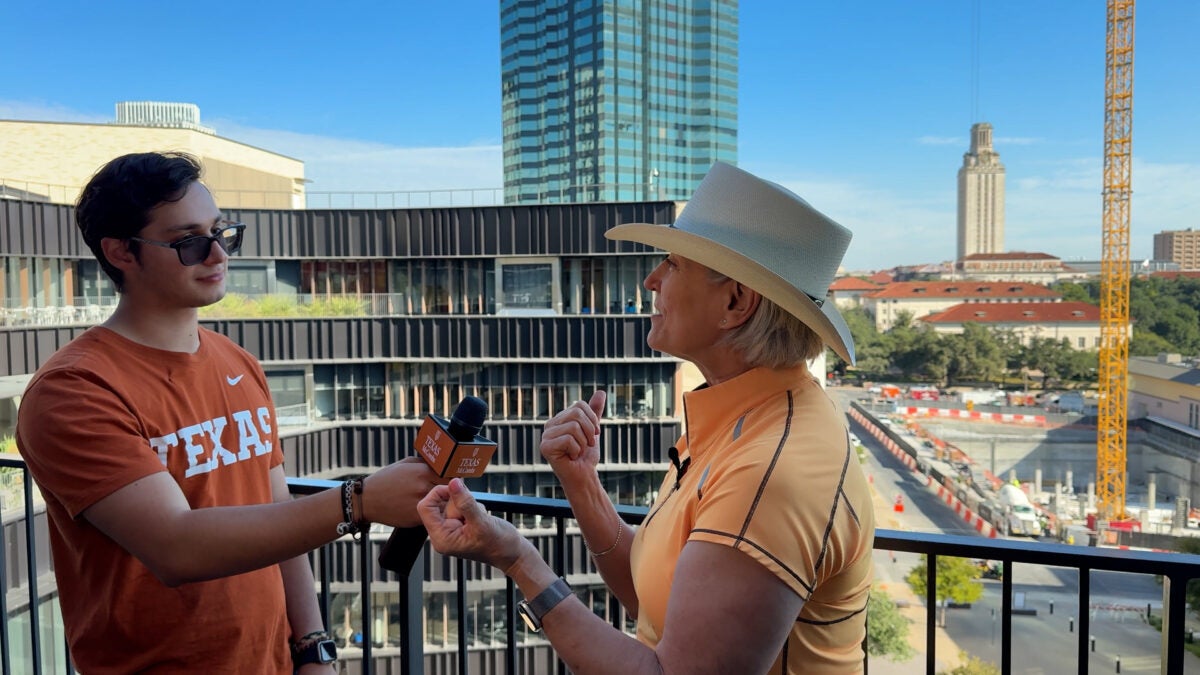Dean Lillian Mills describes a much-anticipated art installation in Mulva Hall during an interview with freshman Business Honors student Diego Beyer.